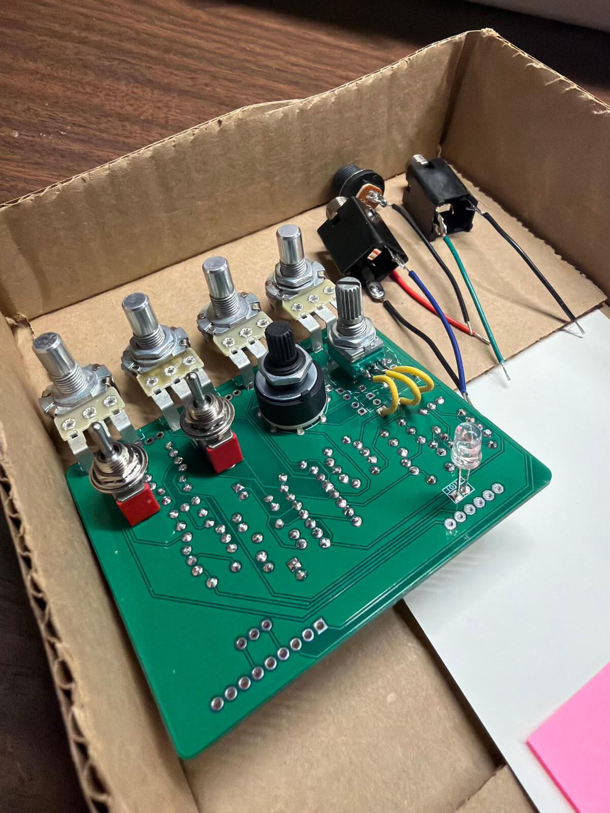 Green Screamer dual-channel pedal circuit during assembly