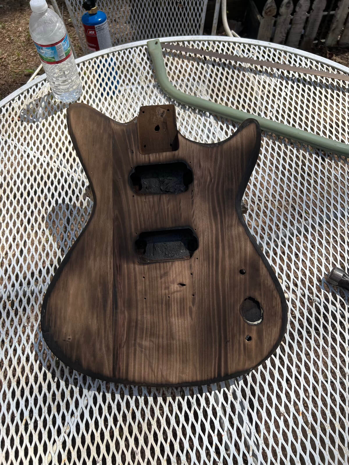 Burned First Act guitar body after sanding back the char