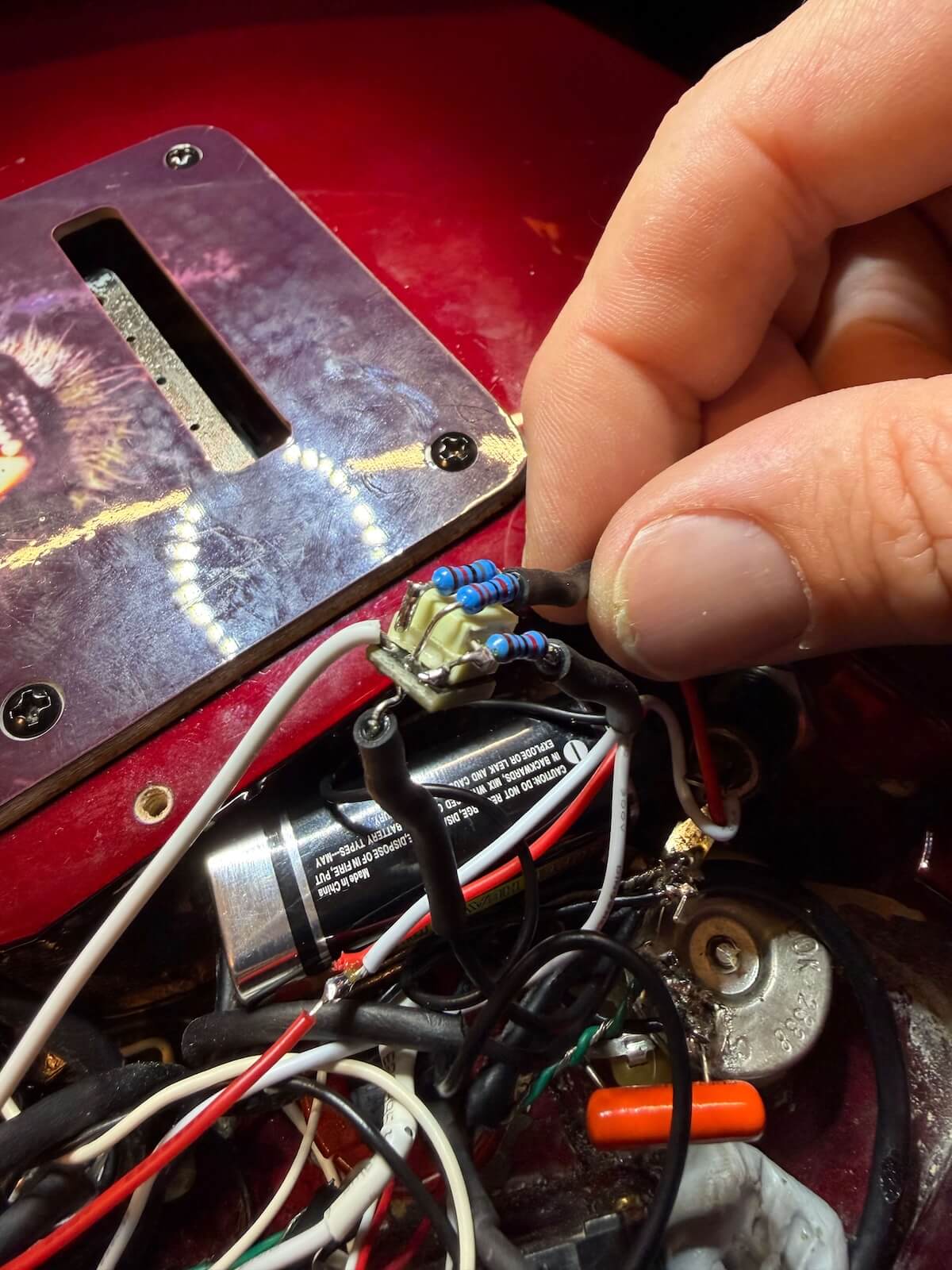 Compact preamp and wiring being installed inside the Jackson control cavity