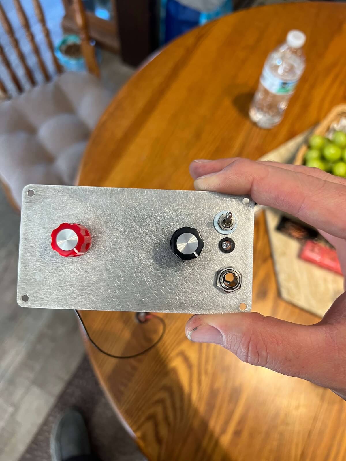 Reused aluminum pedal enclosure panel being fitted as the amplifier control plate